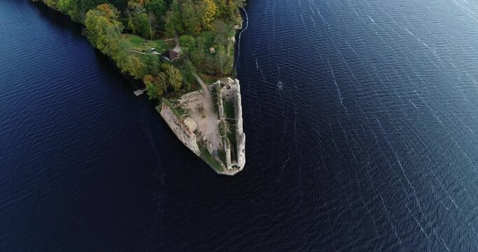 Aerial view of an old stone castle ruins in Koknese, Latvia. Located on a peninsula near the Daugava river and Perse river.