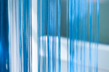 Blue string filament curtain. Selective focus.