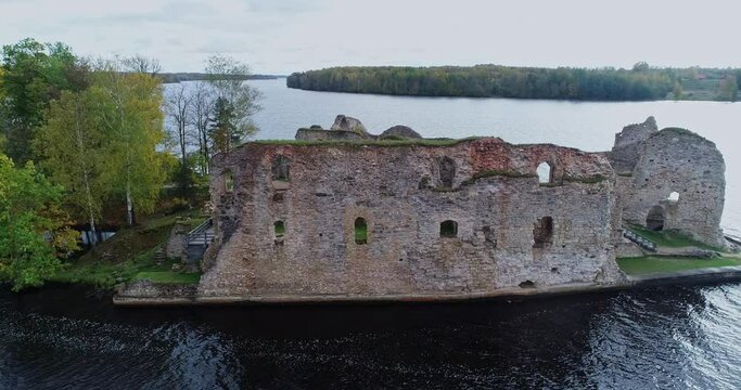 Aerial view of an old stone castle ruins in Koknese, Latvia. Located on a peninsula near the Daugava river and Perse river.