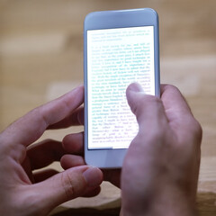 Smart stories. Cropped shot of a person reading text on their phone.