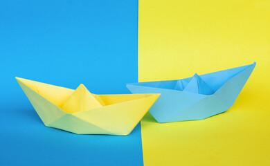 decorative paper ships blue yellow background in the color of the flag of ukraine