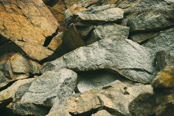 Large pile of stones. Stone rocks. Granite quarry. Abstract background. Abandoned industrial production. 