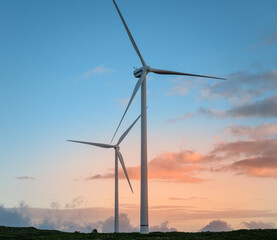 Fototapeta premium Renewable energy concept, wind turbines at sunset