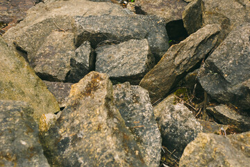 Large pile of stones. Stone rocks. Granite quarry. Abstract background. Abandoned industrial production. 