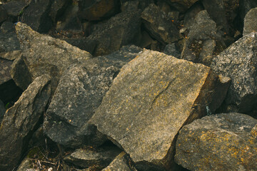 Large pile of stones. Stone rocks. Granite quarry. Abstract background. Abandoned industrial production. 