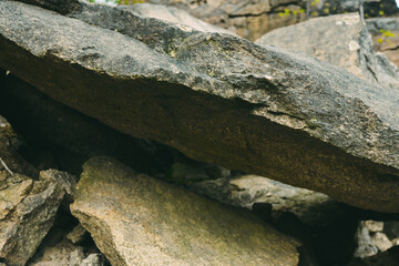 Large pile of stones. Stone rocks. Granite quarry. Abstract background. Abandoned industrial production. 