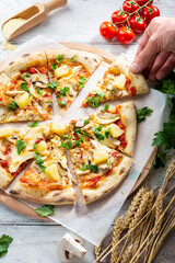 Overhead view of chicken and pineapple pizza sliced food