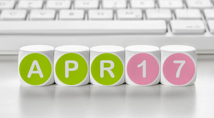 Letter dice in front of a keyboard - April 17