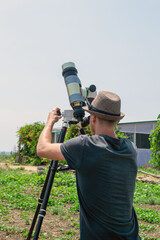 Observing the sun. Astronomer looks through solar telescope