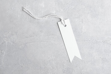 Rectangle strip white tag mockup with white cord, close up. Blank paper rectangular price tag mockup isolated on grey background with copy space, Sale and Black Friday concept