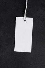 Rectangle white tag mockup with white cord, close up. Blank paper rectangular price tag mockup...