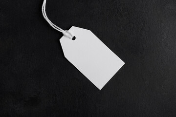 Rectangle white tag mockup with white cord, close up. Blank paper rectangular price tag mockup...