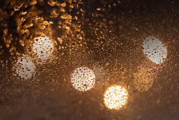 Blurred background with raindrops and lights.