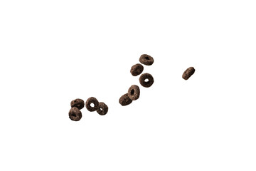 Chocolate rings cereal spill out into a bowl. Breakfast.