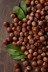 hazelnuts with leaves on the wooden table from above