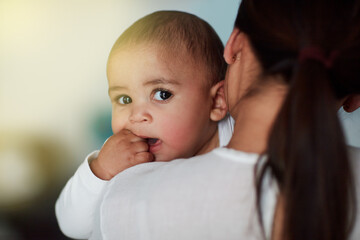 Hold my calls until Im done bonding with Mom. Shot of a loving mother carrying her baby boy at home.