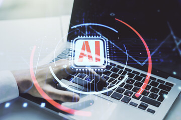 Double exposure of creative artificial Intelligence abbreviation with hand typing on computer keyboard on background. Future technology and AI concept