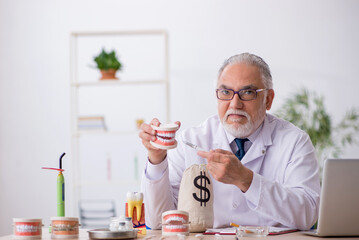 Old male doctor dentist in remuneration concept