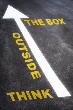 Think outside the box written on the road. Business planning concept and new year beginning success idea