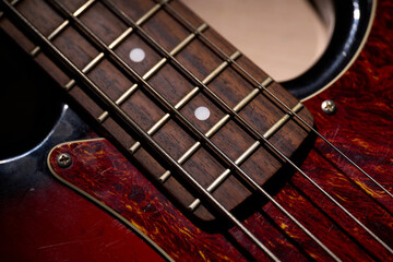 Metallic volume treble guitar bass knobs. Electric guitar. Red electric bass guitar close-up....