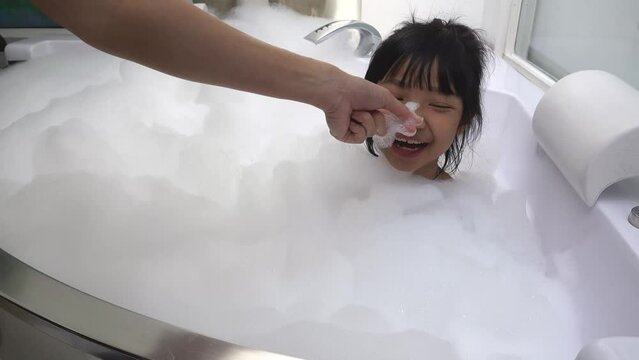 Asian girls having fun in a white bubble bath