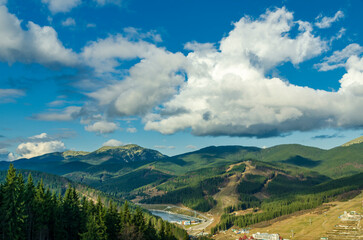 Naklejka premium Magnificent panoramic view the coniferous forest on the mighty Carpathians Mountains and beautiful blue sky background. Beauty of wild virgin Ukrainian nature. Peacefulness.
