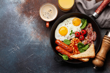 English breakfast with fried eggs, beans, bacon and sausages