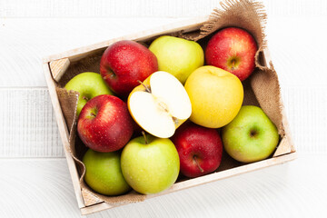 Colorful ripe apple fruits in box
