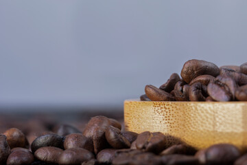 roasted coffee grains on black texture background