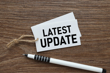 Latest Update text on a business card on the table