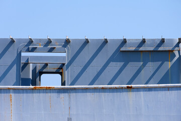 Part of navigation bridge room structure on the old gray vessel hull during renovation work against...