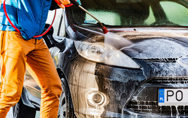 A vehicle in a coin-operated self-service car wash