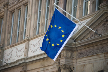 Closeup of european union flag on the stoned facade of building