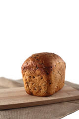 a loaf of wholegrain bread on cutting board
