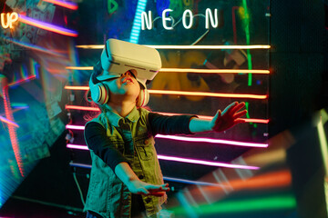 Little girl wearing glasses of virtual reality playing