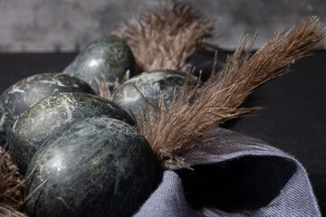 Gray easter eggs on black background