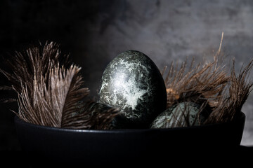 Gray easter eggs on black background