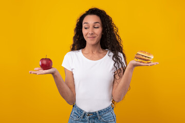 Portrait of Smiling Lady Holding Apple And Burger