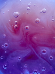 Bubbles and abstract pattern made with liquid soap, blue and purple colors, background, vertical image