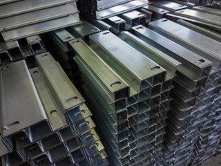 full frame view on stacks of profile bent sheet metal parts - obrazy, fototapety, plakaty