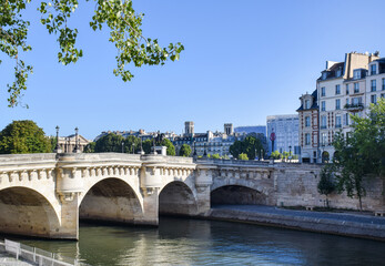 Beautiful panoramic view from the Seine River to the bridge and the city landscape on a sunny summer day. Paris, France