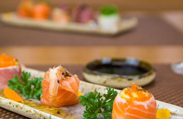 Platter decorated with different flavors of elegant sushi.
