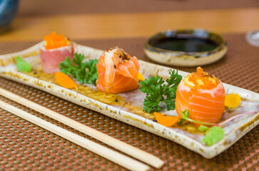 Platter decorated with different flavors of elegant sushi.