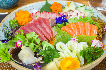 Platter decorated with different flavors of elegant sushi.