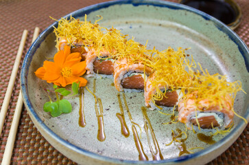 Platter decorated with different flavors of elegant uramaki sushi.