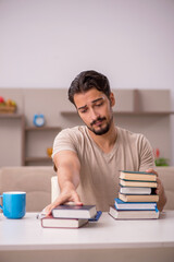 Young male student studying at home during pandemic