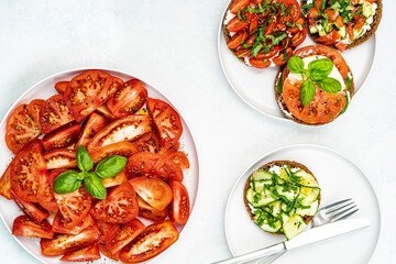 Healthy fresh salad with tomatoes and basil, sandwich with tomatoes,cucumber,feta,mozzarella and herbs. Healthy food concept.