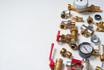 Plumbing parts and accessories on the white top view background with copy space. Pipeline parts.