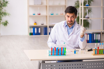 Young male chemist working at the lab in vaccination concept