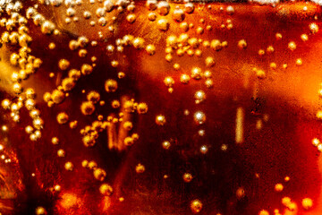 Obraz na płótnie Canvas macro soft drink texture,Soft drink glass with ice splash on dark background. Cola glass in celebration party concept.